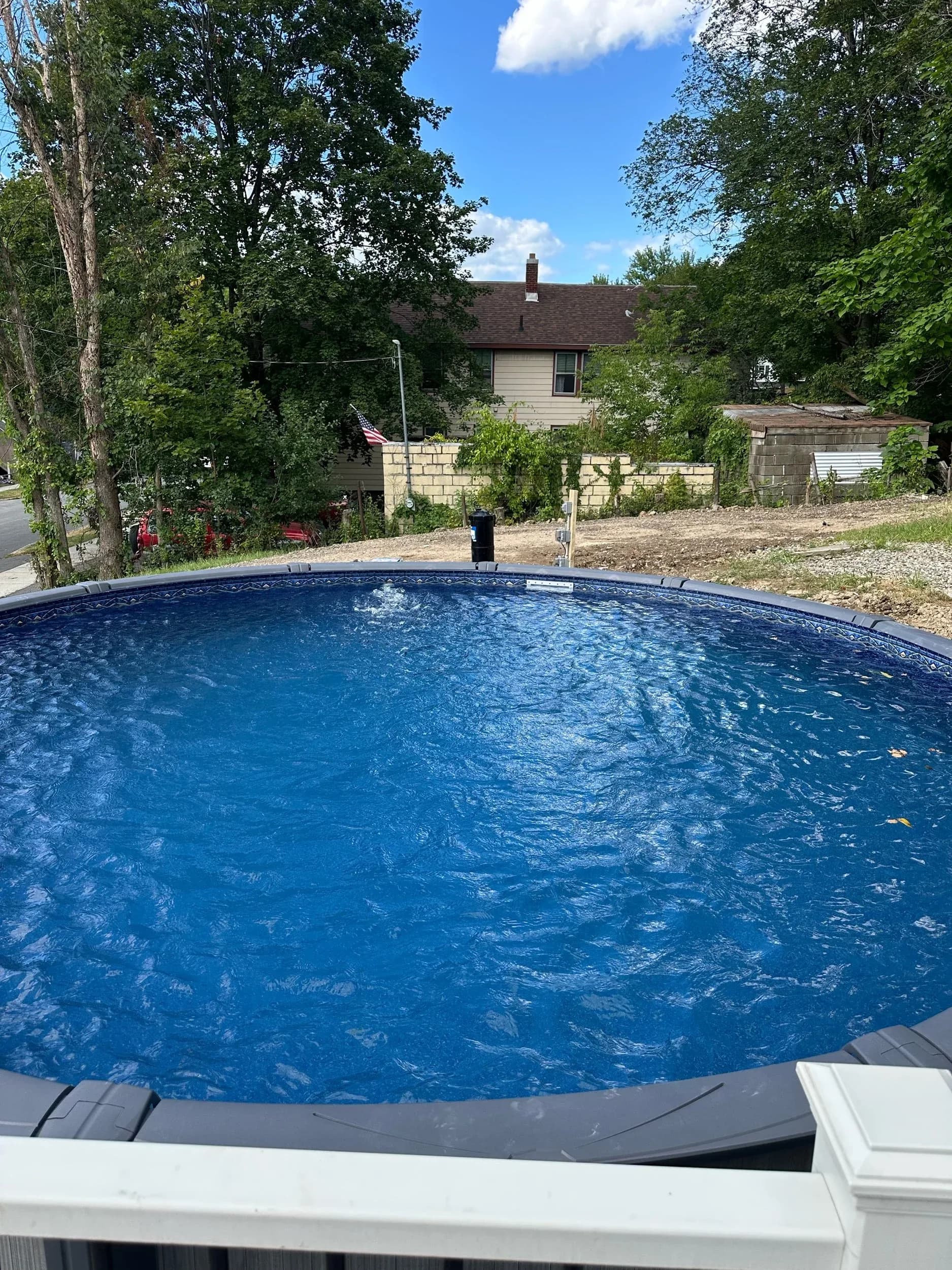 Above Ground Pool Water View With Electrical Post In Background