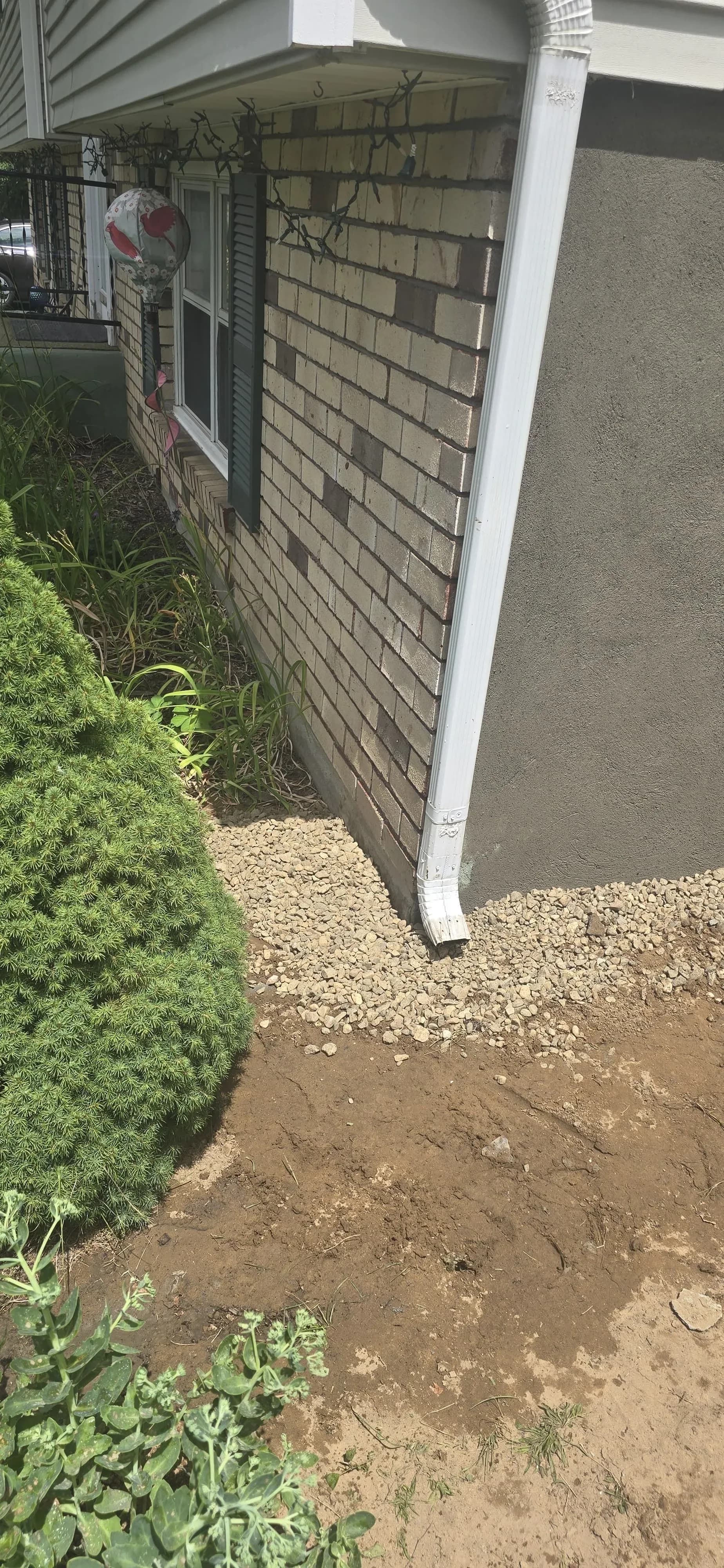 Brick House Corner New Downspout Gravel Bed Landscaping