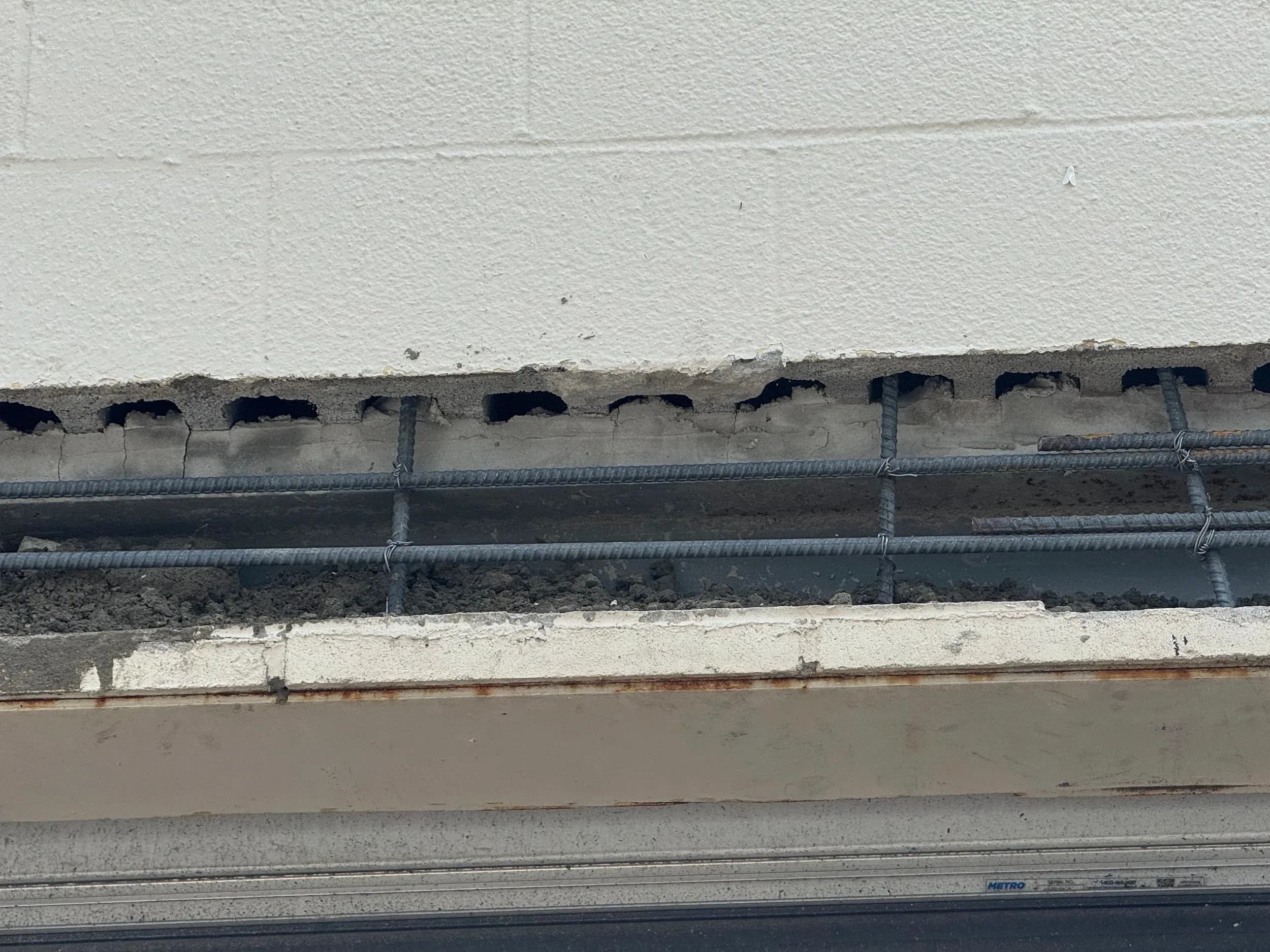 Cracked Concrete Lintel Rebar Closeup Above Dock Door