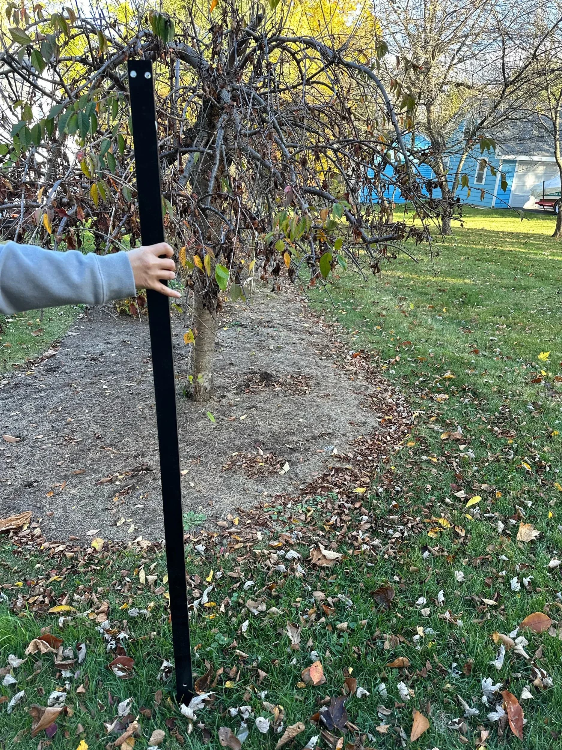 Custom House Number Sign Post Being Positioned Near Tree