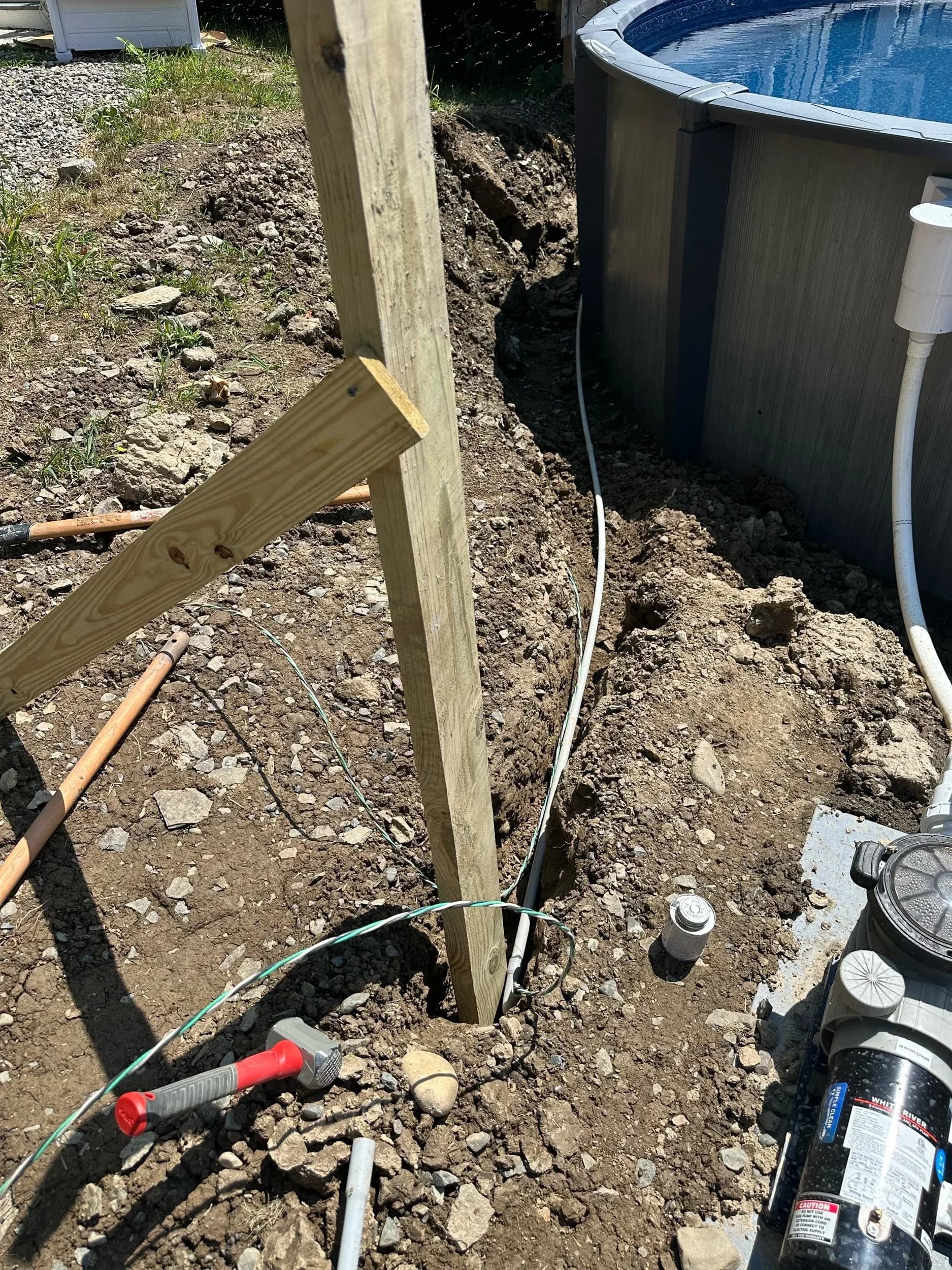 Electrical Post And Trench Beside Above Ground Pool