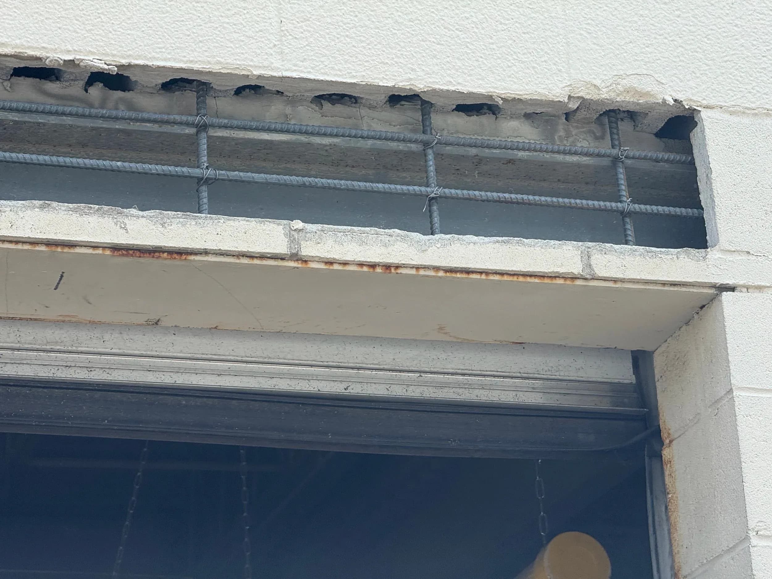 Exposed Rebar In Damaged Lintel Above Loading Dock Door