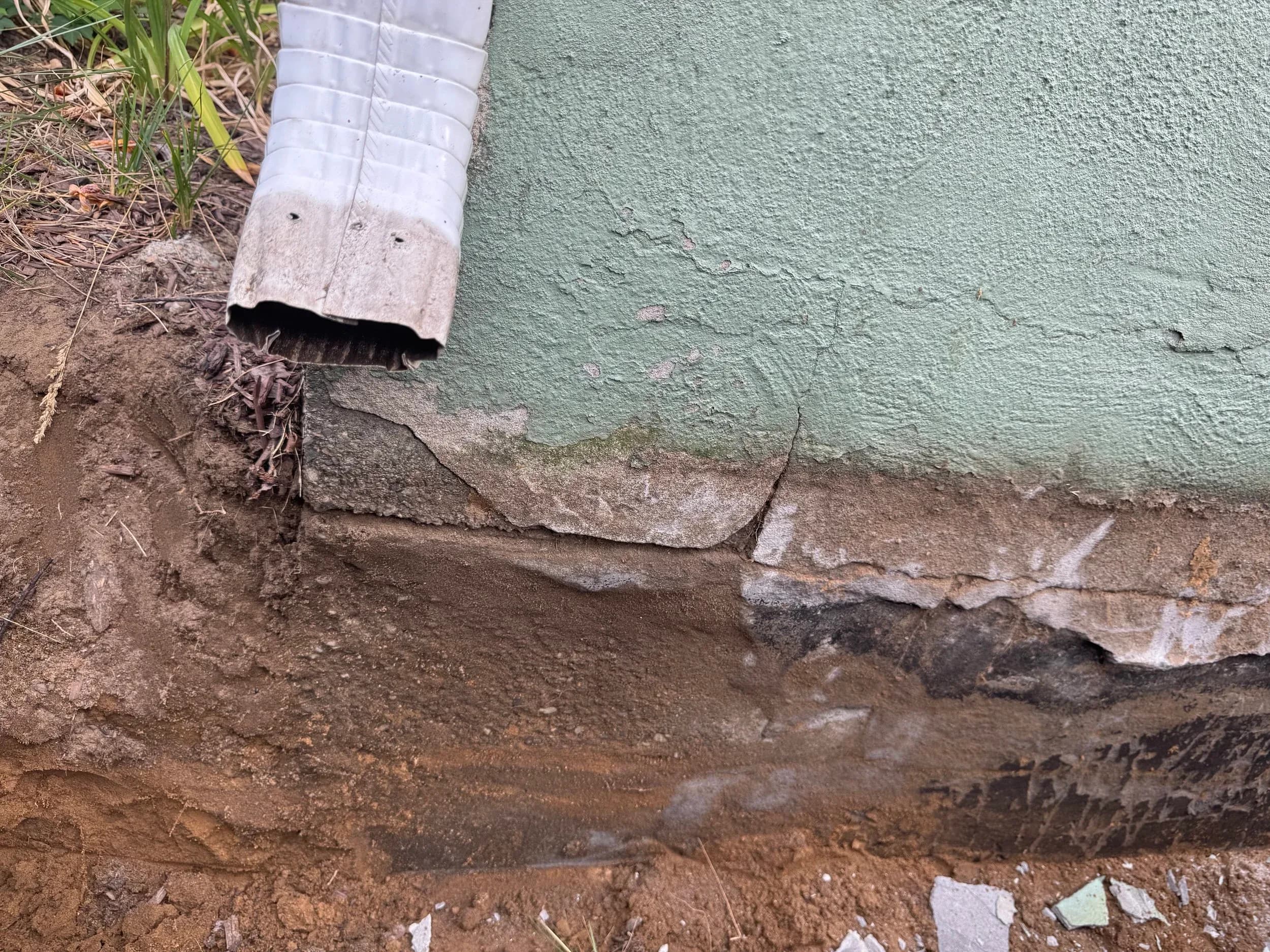 Foundation Corner Excavation Downspout Water Damage