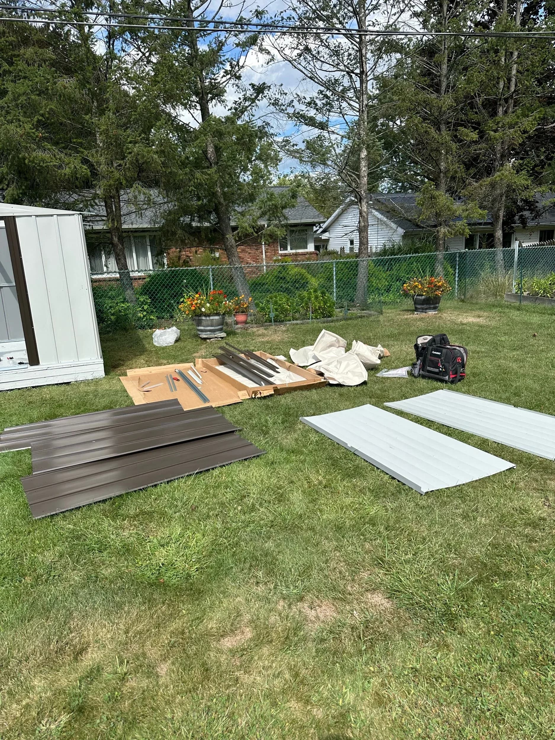 Prefab Shed Building Materials Laid Out On Lawn