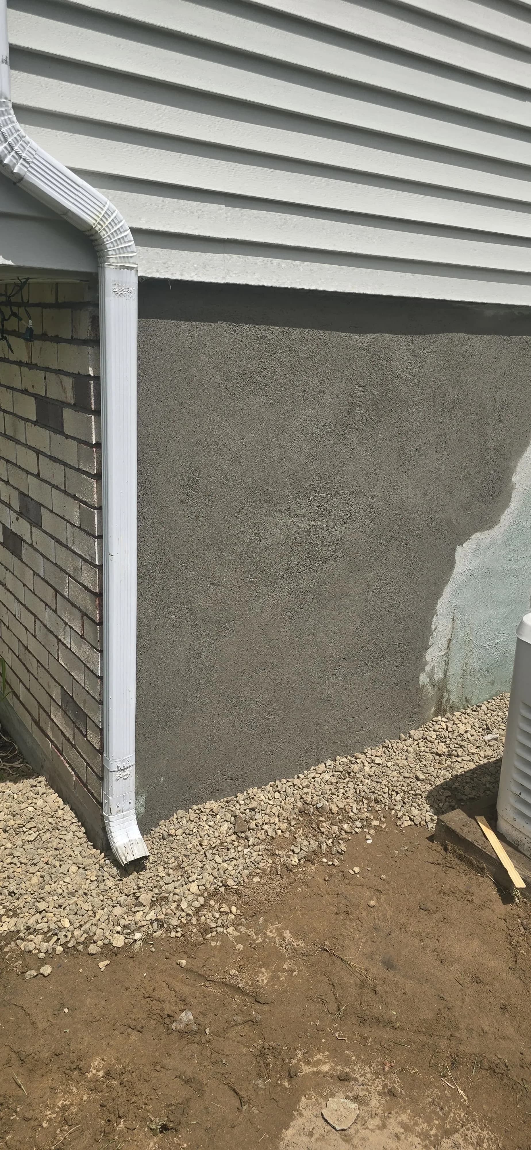 Repaired Foundation Wall Fresh Parging Gravel Drainage Bed