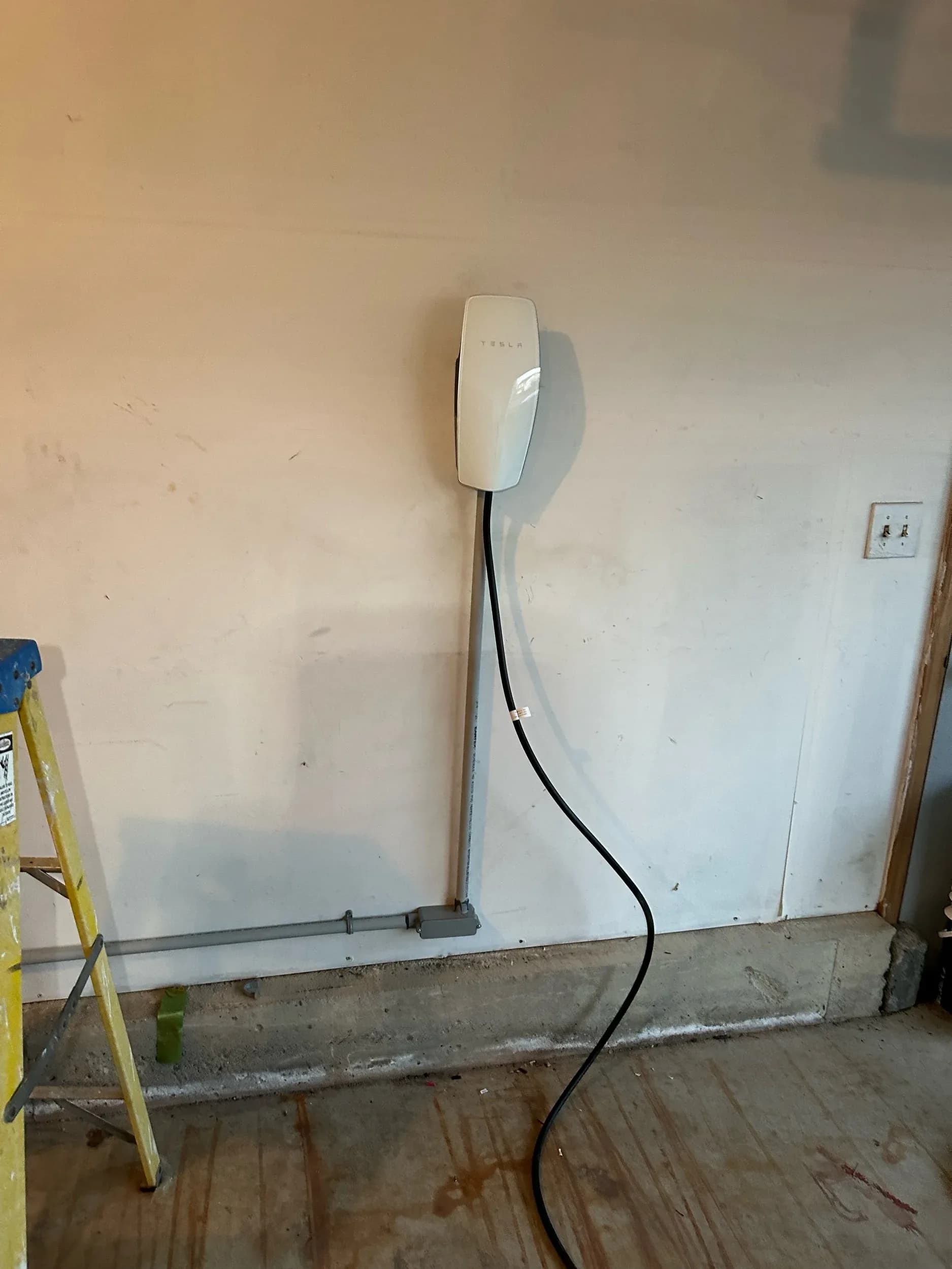 Tesla Wall Charger Installed Garage Wide View