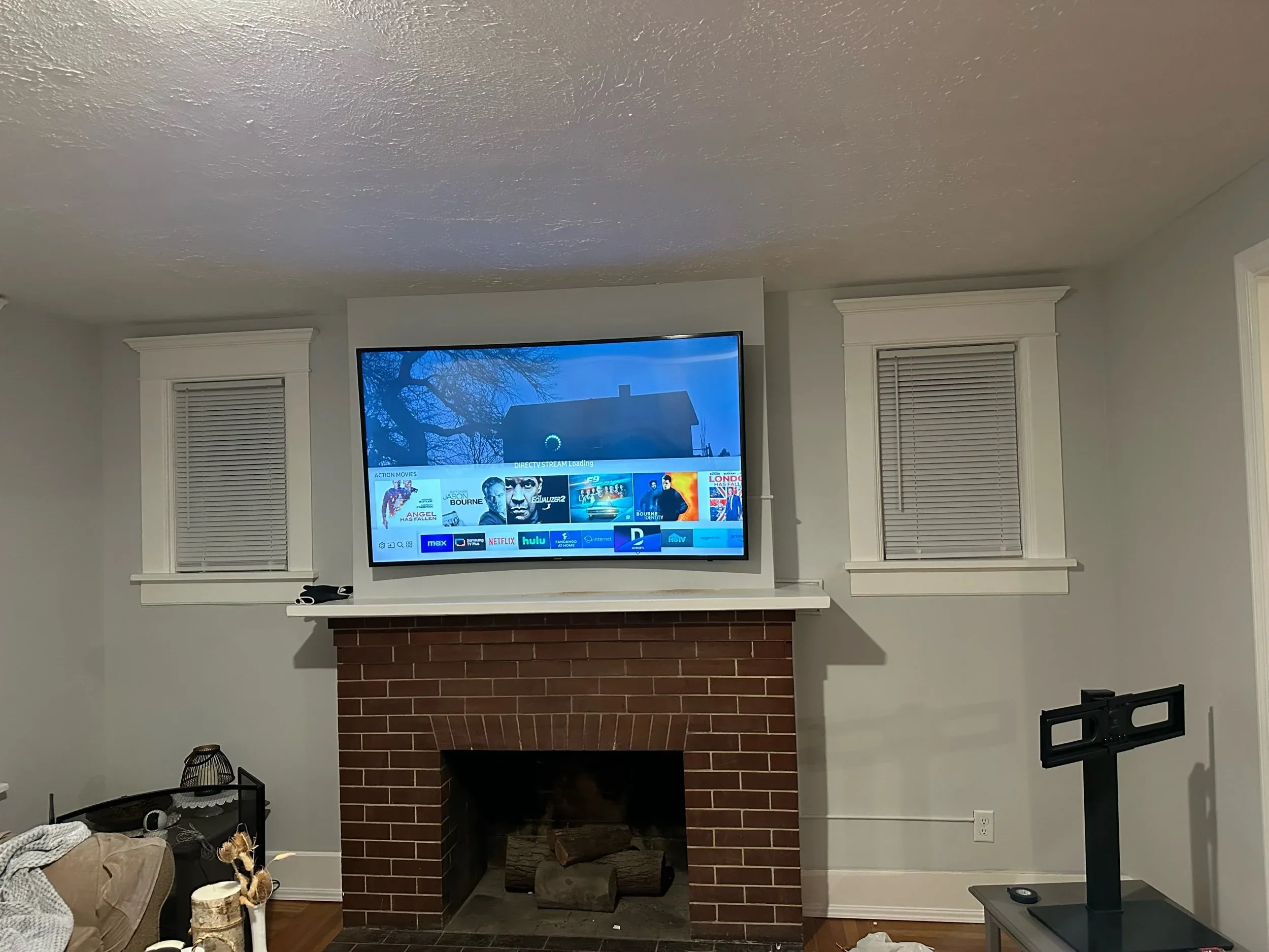 TV Mounted Above Brick Fireplace Living Room