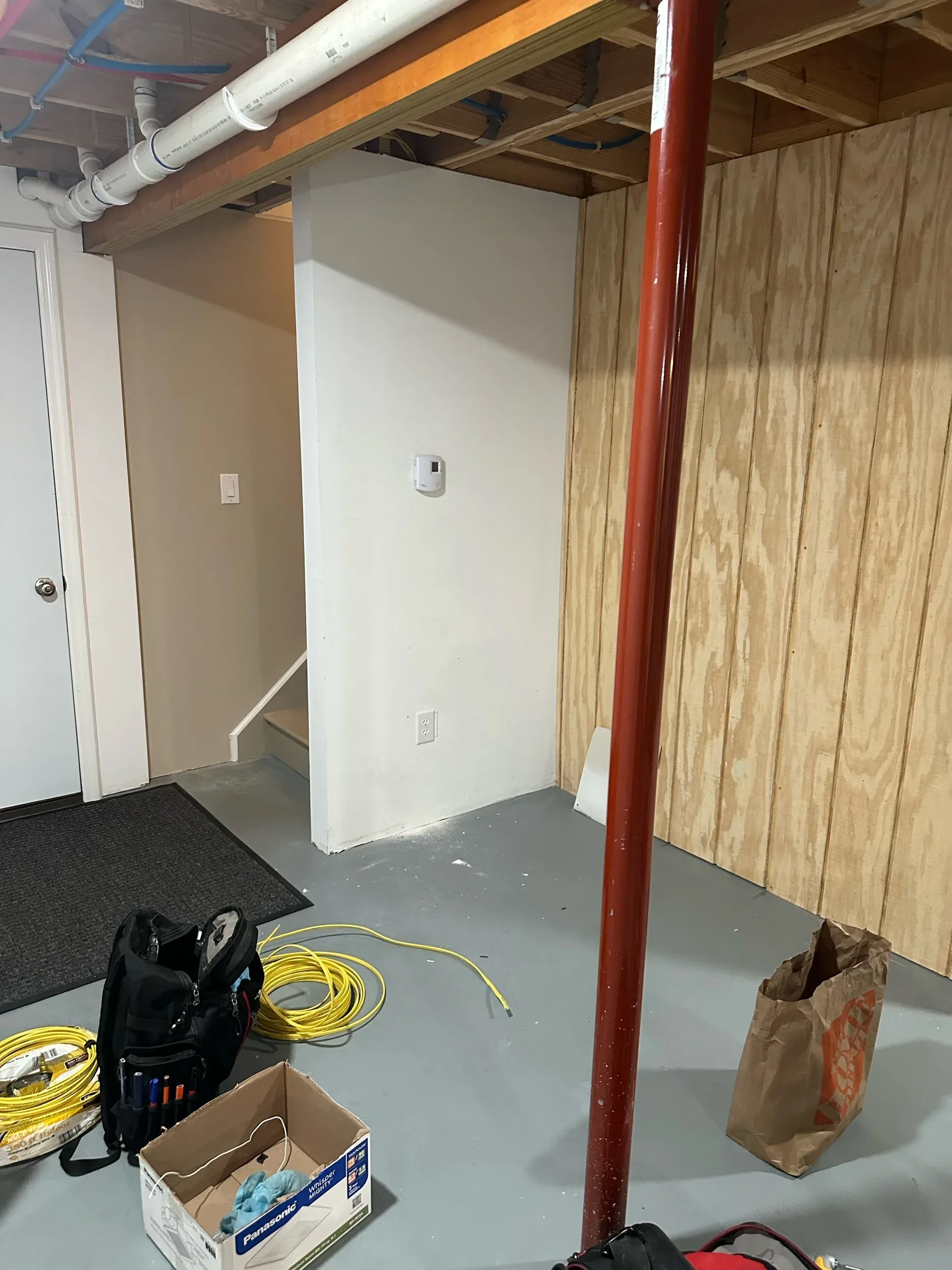 Unfinished Basement Corner With Smoke Detector And Tools