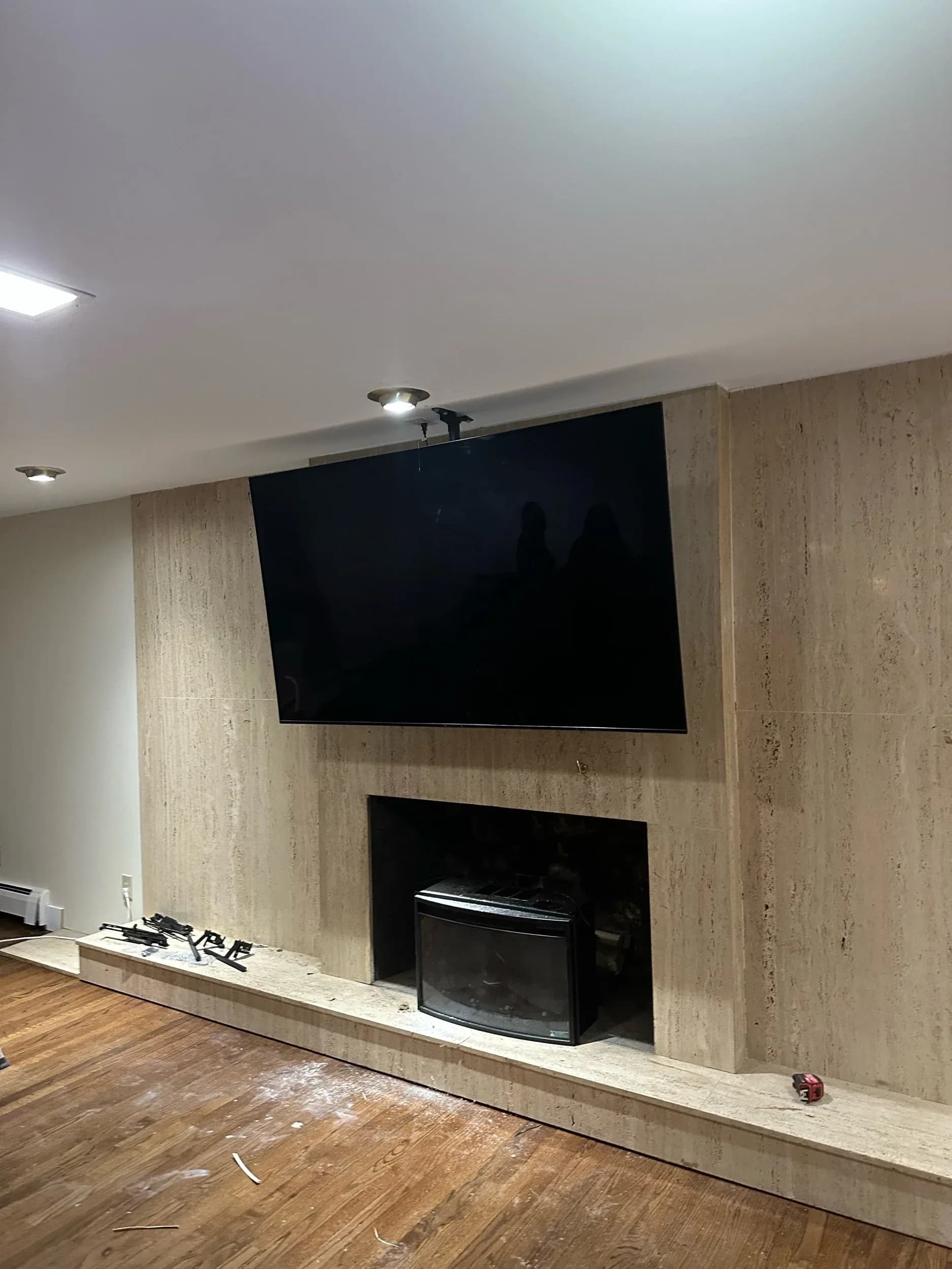 Wall Mounted TV Above Travertine Fireplace Living Room