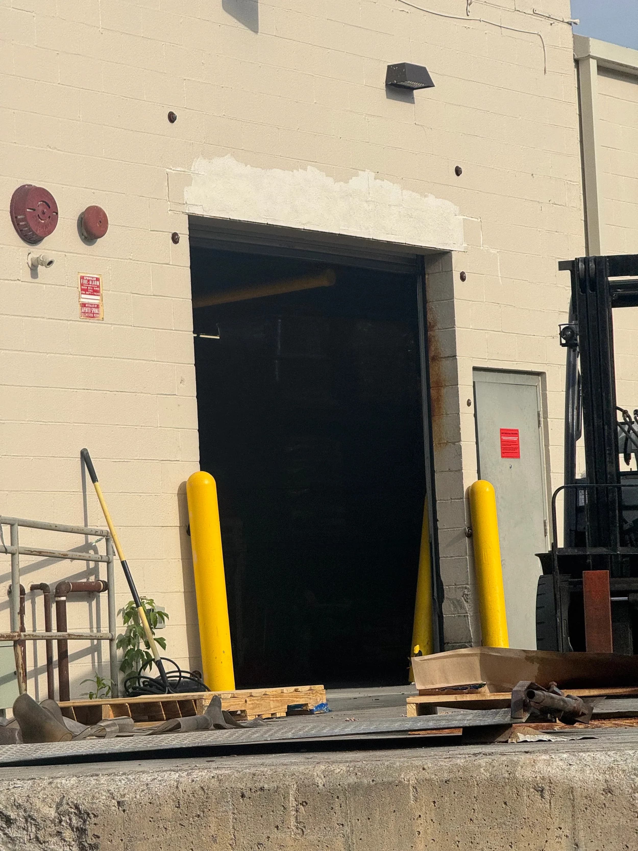 Warehouse Loading Dock Door Exterior With Bollards