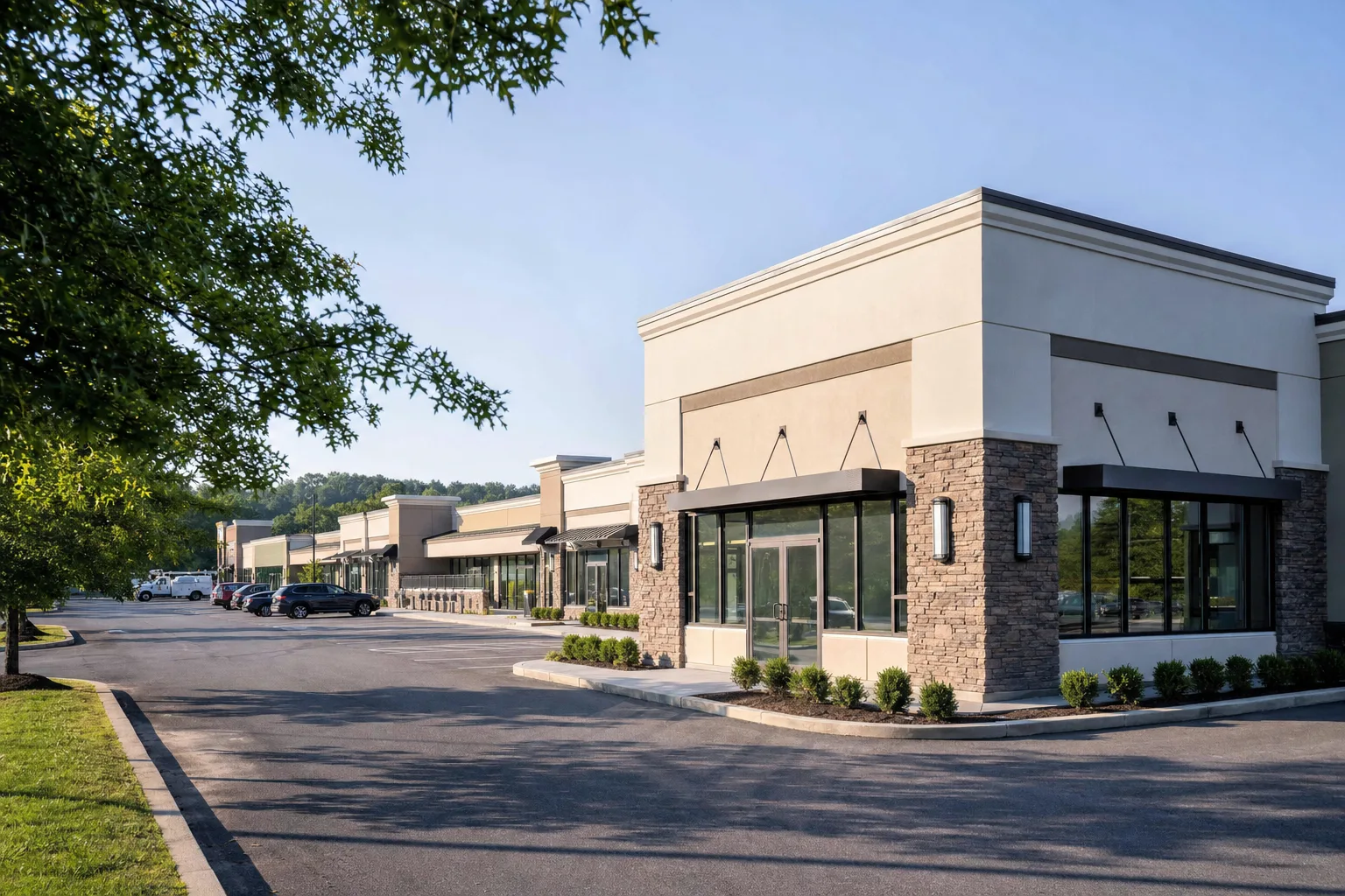 One-story suburban office and retail building with large windows and a parking lot in Colonie, NY