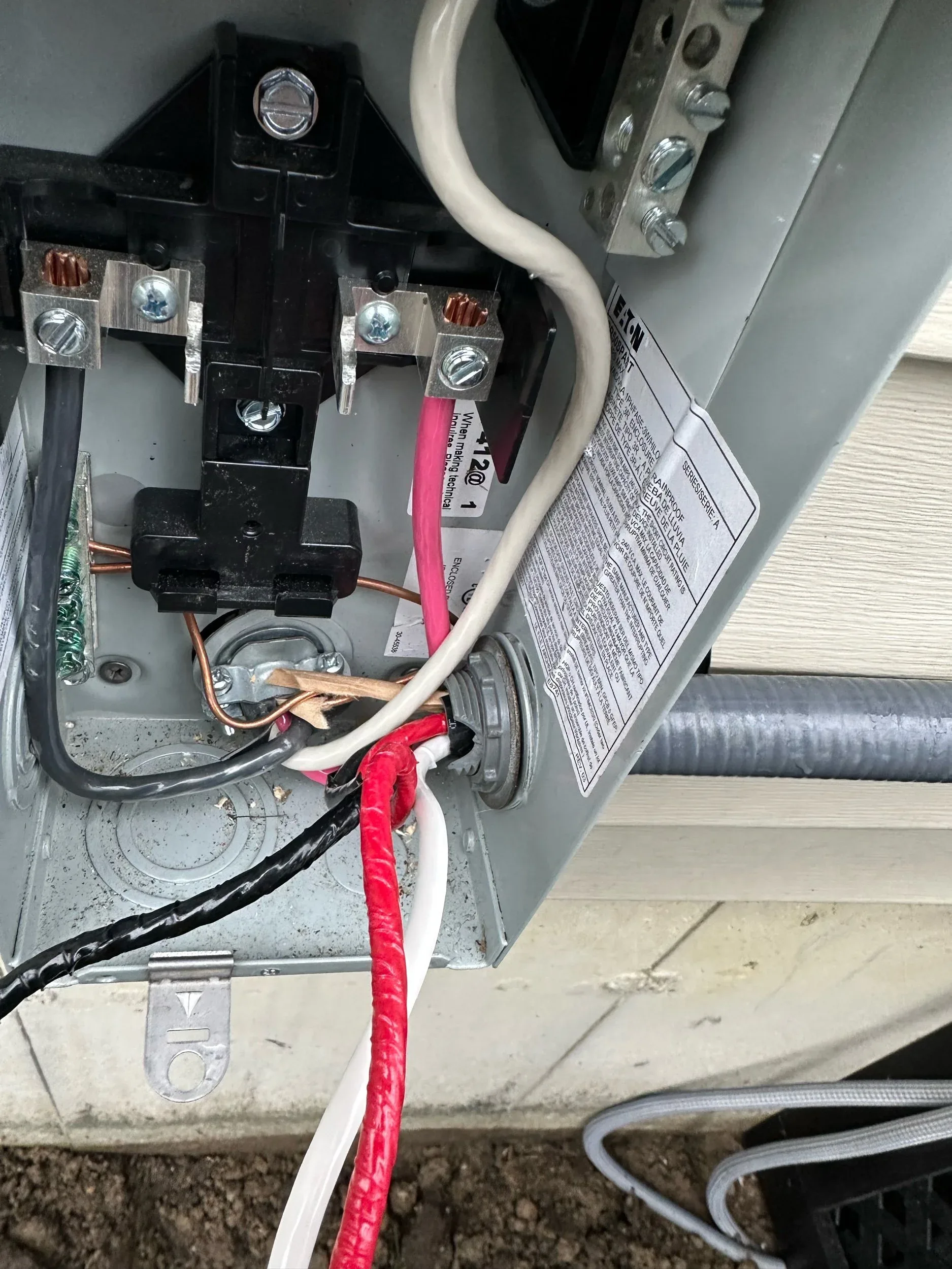 Close-up of outdoor meter base and panel wiring