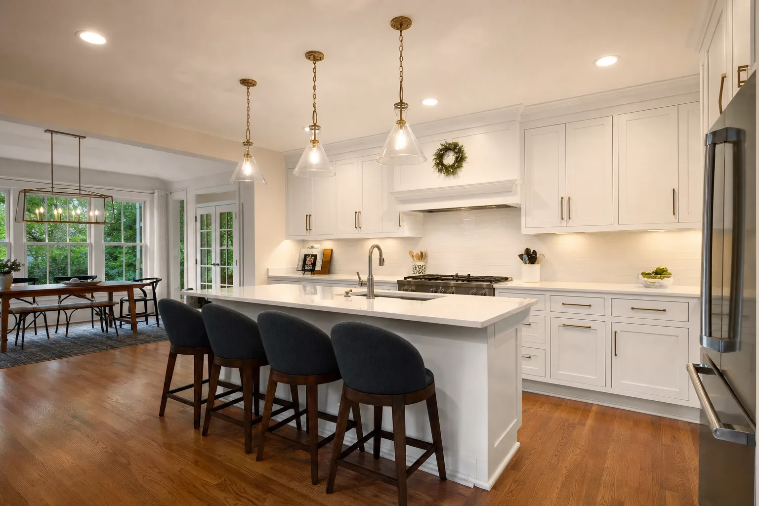 Finished kitchen remodel with an island, pendant lights, recessed lights and under-cabinet lighting
